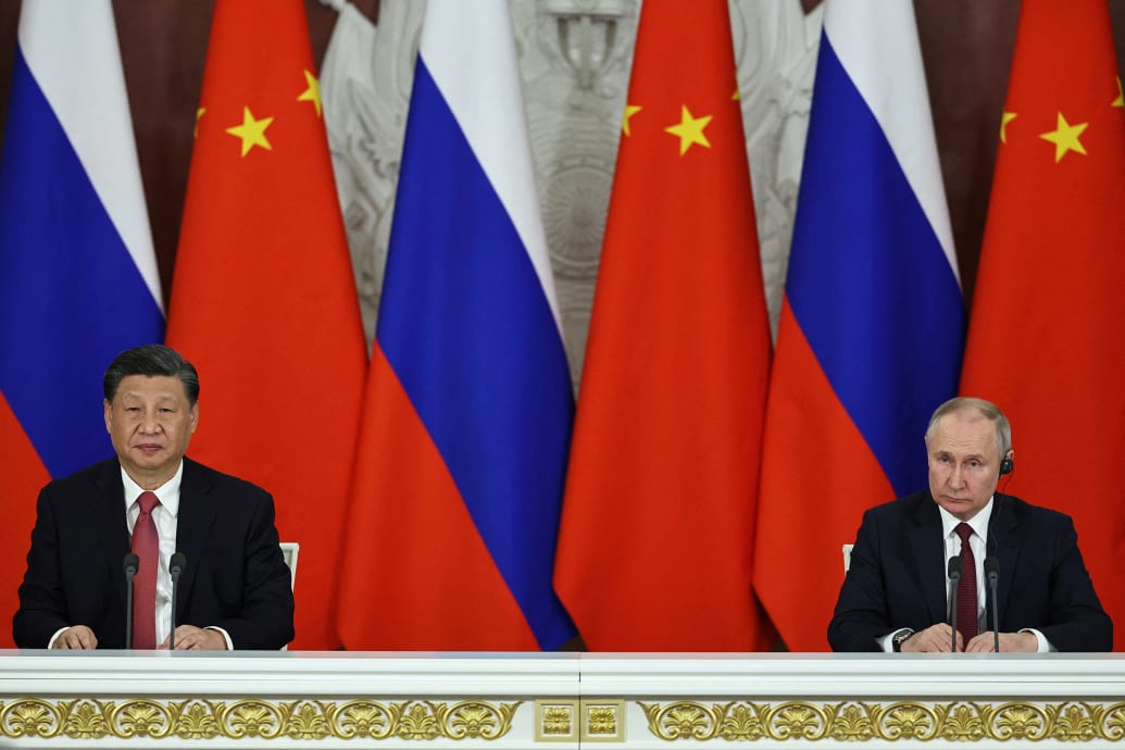 An image of Russian President Vladimir Putin and Chinese President Xi Jinping sitting next to each other during a press conference in March 2023.
