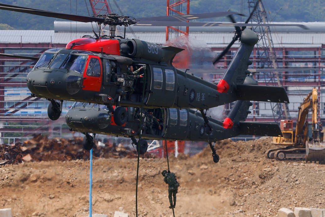 A photo of a soldier rappelling down from a Black Hawk helicopter in New Taipei City, Taiwan.