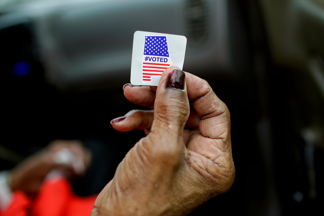 A photo of Sadie Janes holding up a voting sticker following the casting of her ballot in Montgomery, Alabama in 2020.