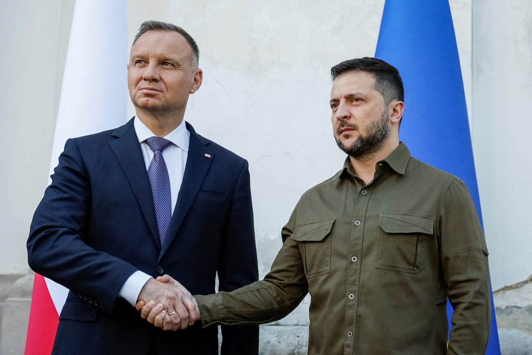 A photo of Ukrainian President Volodymyr Zelenskyy and Polish President Andrzej Duda shaking hands in July 2023.