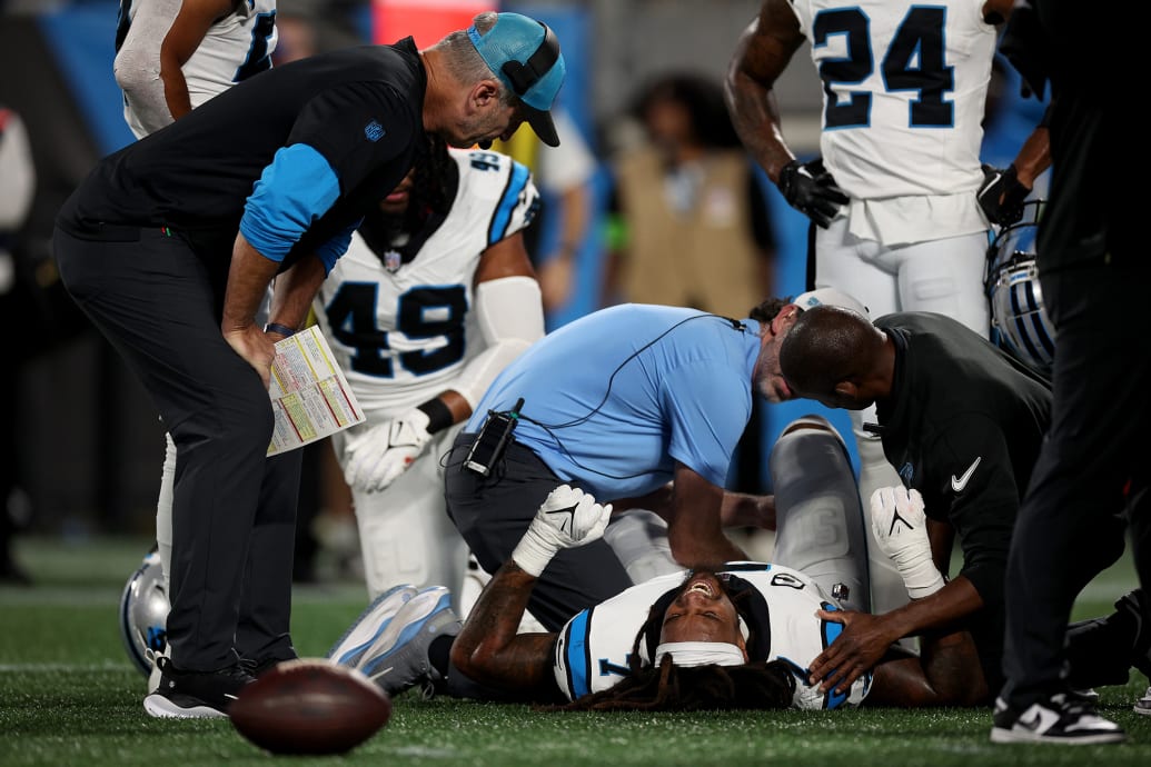 Shaq Thompson of the Carolina Panthers is looked over on the field after being injured.