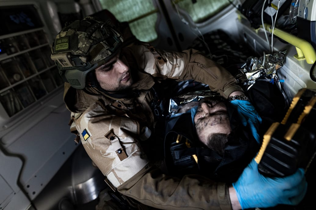 An Ukrainian army medic transfer a wounded soldier at a stabilization point in the direction of Bakhmut, Ukraine, Nov. 10 2023.
