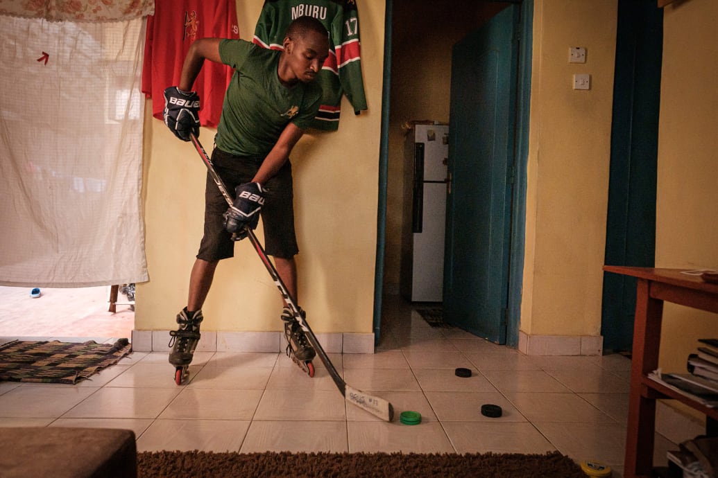 Benjamin Mburu, Kenyan architect and player of Kenya's ice hockey team Ice Lions, practices stick handling as his daily training in his living room in Nairobi.