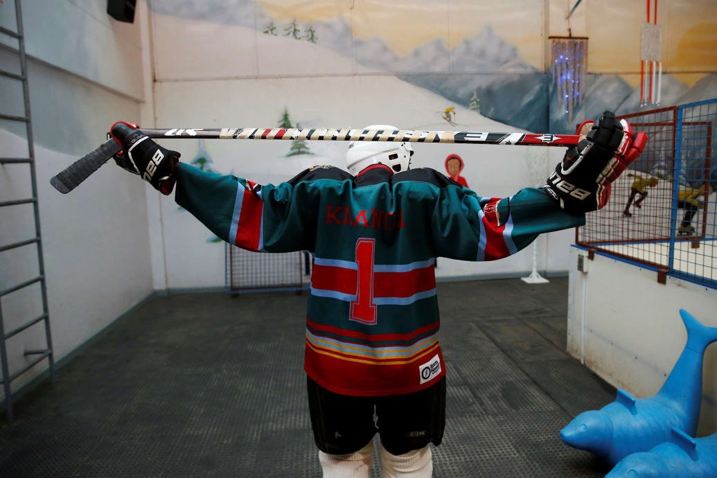 A member of Kenya's ice hockey team stretches before a practice session in East Africa's only ice rink, in Nairobi, Kenya on Jan. 24, 2018.