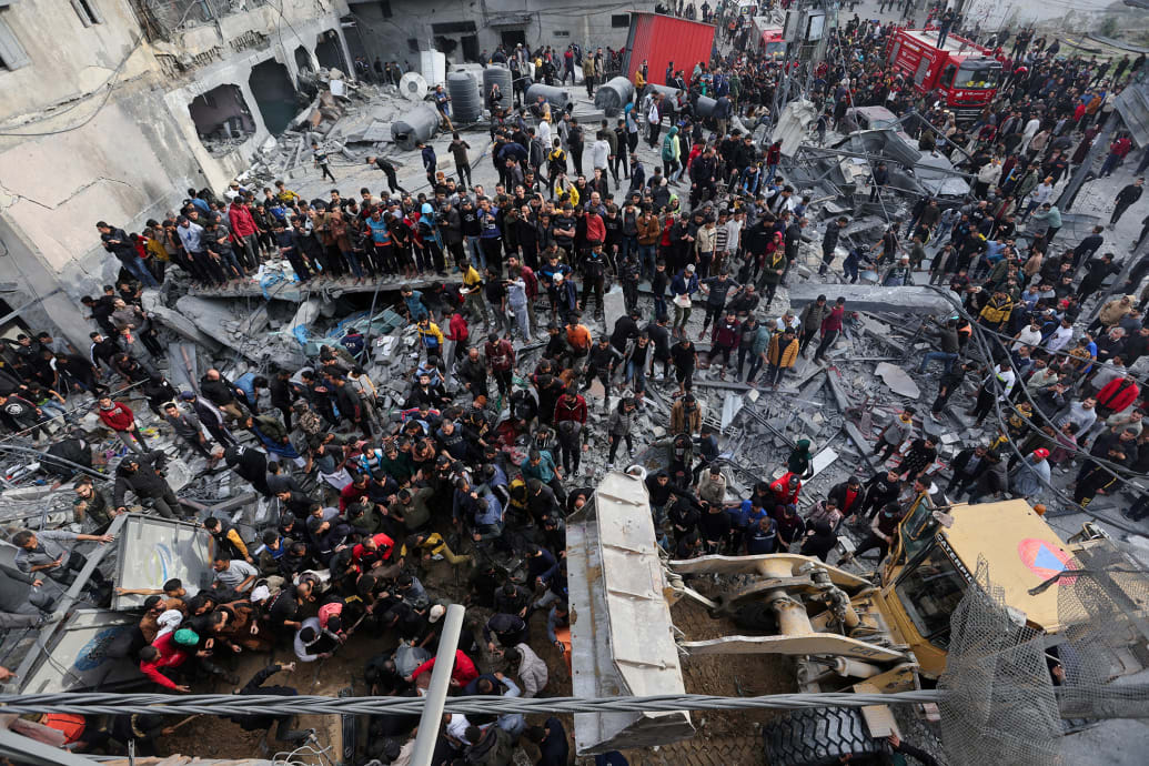 Palestinians search for casualties at the site of an Israeli strike on a house in Rafah, southern Gaza on Dec. 20, 2023.
