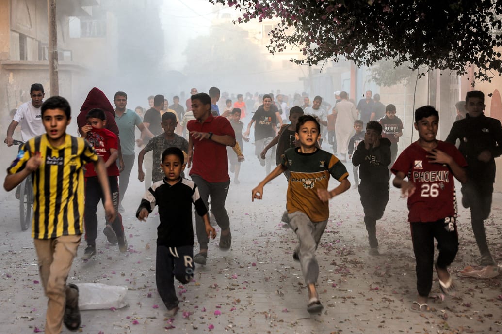 Palestinian children flee from an Israeli bombardment in Rafah.