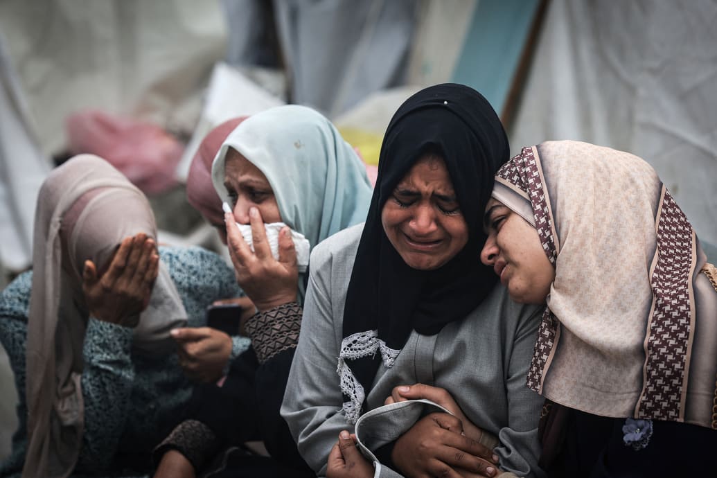 Palestinians mourn their relatives, killed in an overnight Israeli strike.