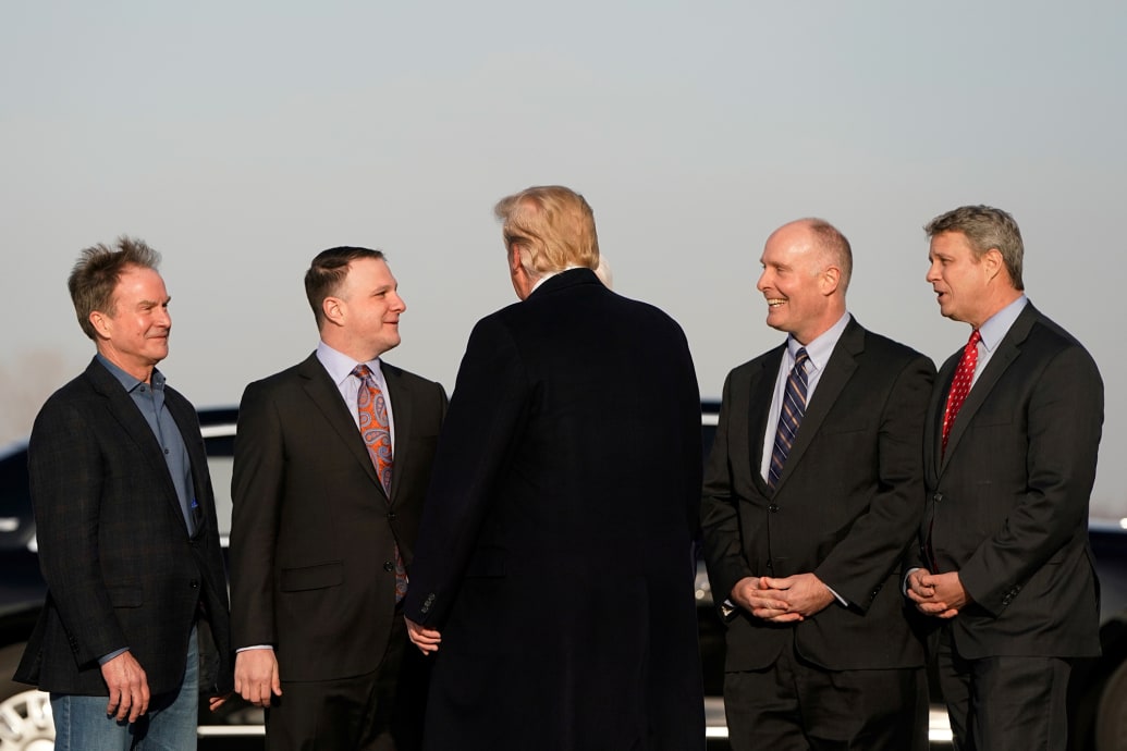 Donald Trump is greeted by U.S. Representatives from Michigan Bill Huizenga, John Moolenaar, and Jack Bergman, Michigan State Rep. Matt Hall and Former Michigan State Attorney General Bill Schuette during a 2019 trip to Grand Rapids, Michigan.