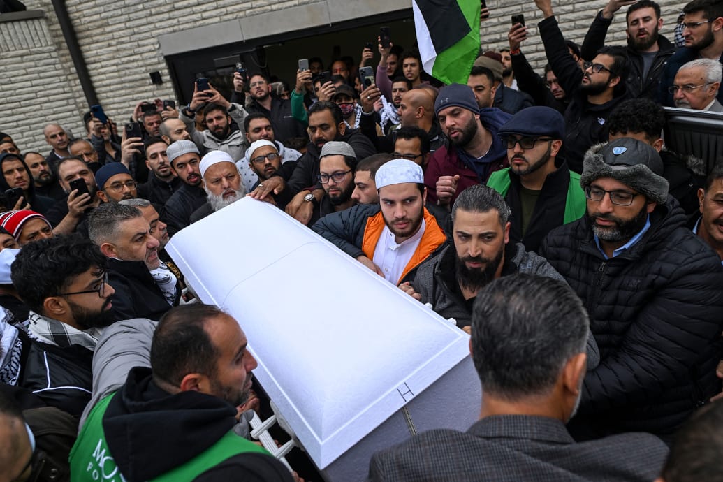 Oday Al-Fayoumi holds the casket with the remains of his 6-year-old Palestinian American son Wadea Al-Fayoumi.
