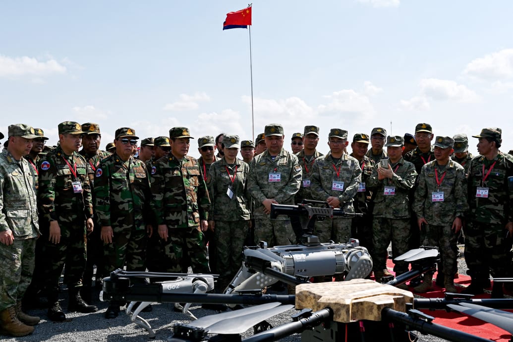 Chinese and Cambodian military attend a demo of robot battle dogs.
