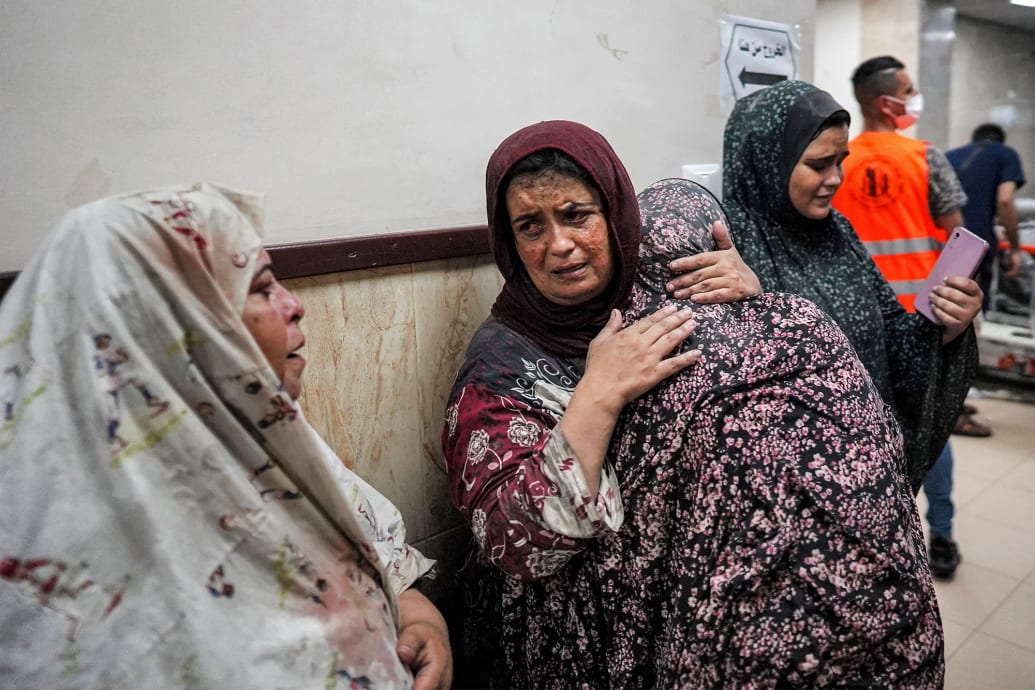 A woman embraces another inside the Al-Aqsa Martyrs Hospital.