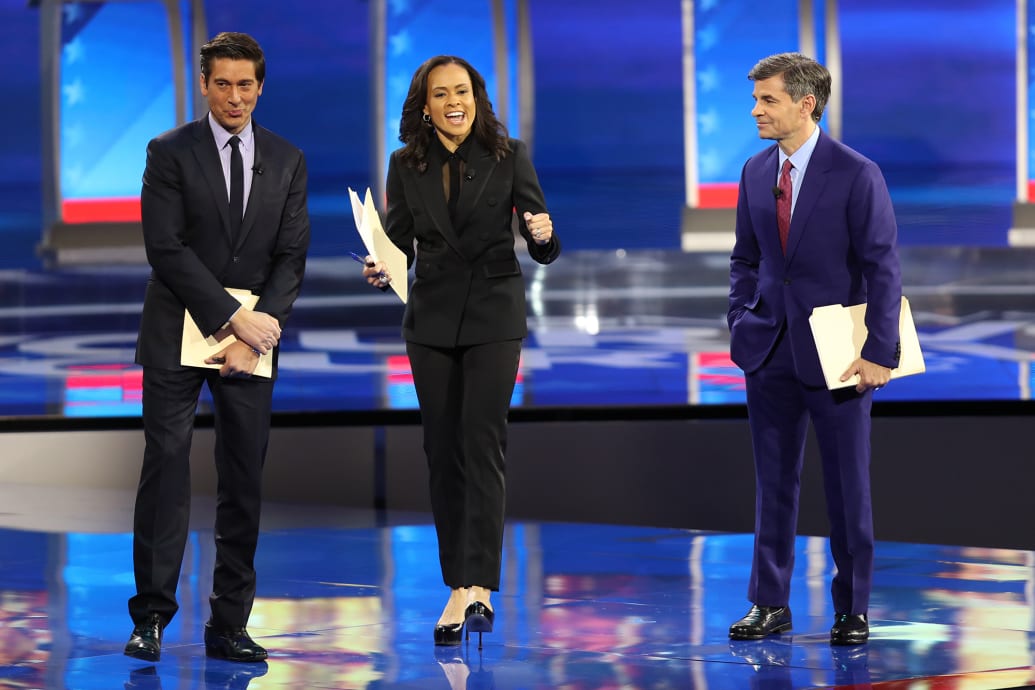 ABC network anchors and debate moderators David Muir, Linsey Davis and George Stephanopoulos speak on stage prior to the Democratic presidential primary debate in the Sullivan Arena at St. Anselm College on February 07, 2020 in Manchester, New Hampshire.