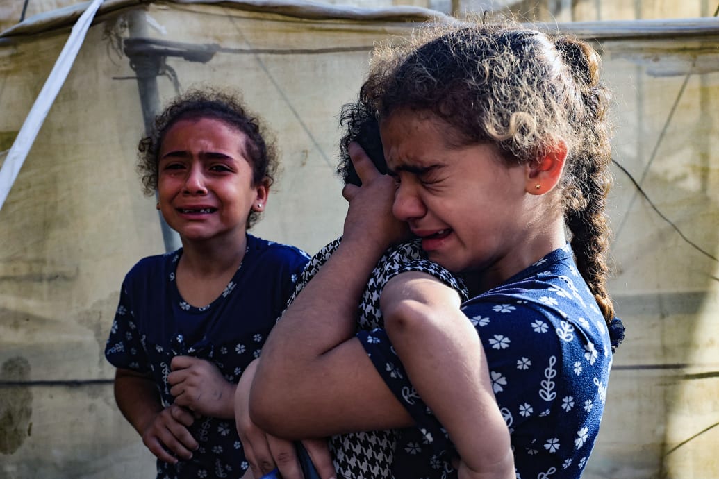 Children react during the funeral of the Faojo family.