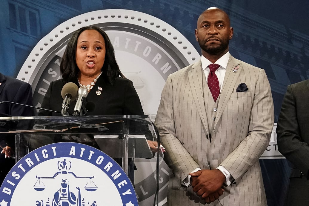 Fulton County District Attorney Fani Willis speaks at a press conference next to prosecutor Nathan Wade.
