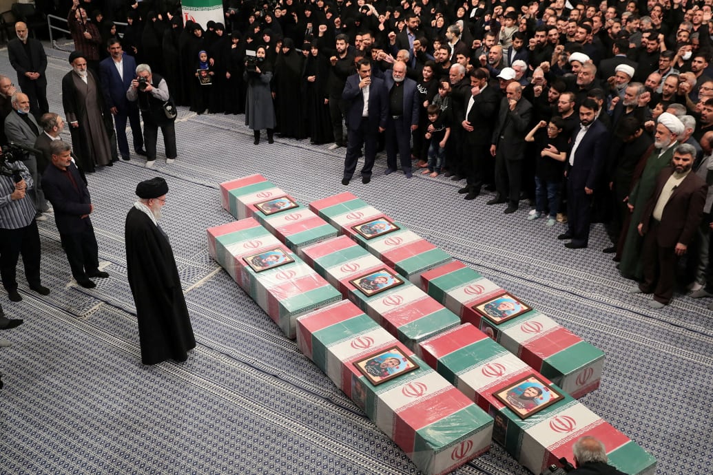 Iran's Supreme Leader, Ayatollah Ali Khamenei looks at the coffins of members of the Islamic Revolutionary Guard Corps.