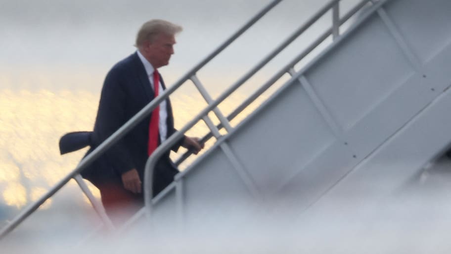 Former U.S. President Donald Trump boards his plane at Atlanta Hartsfield-Jackson International Airport after turning himself in to be processed at Fulton County Jail after his Georgia indictment, in Atlanta, Georgia