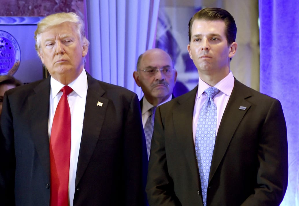 Donald Trump and his son Donald, Jr., with Allen Weisselberg (C)