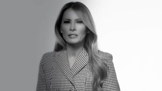 Melania Trump in a houndstooth blazer speaks to the camera to promote her new memoir.