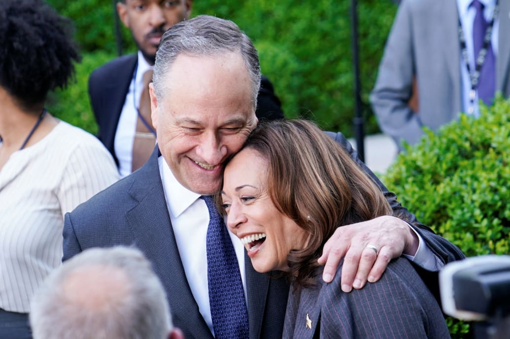 Doug Emhoff and Kamala Harris smile while embracing each other