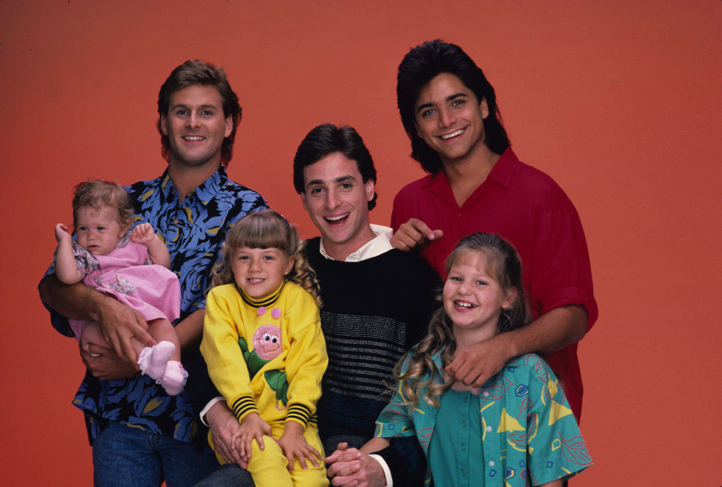 Bob Saget, Mary Kate/Ashley Olsen, Jodie Sweetin, Candace Cameron, Dave Coulier and John Stamos pose for the Full House season one cast portrait in 1987.