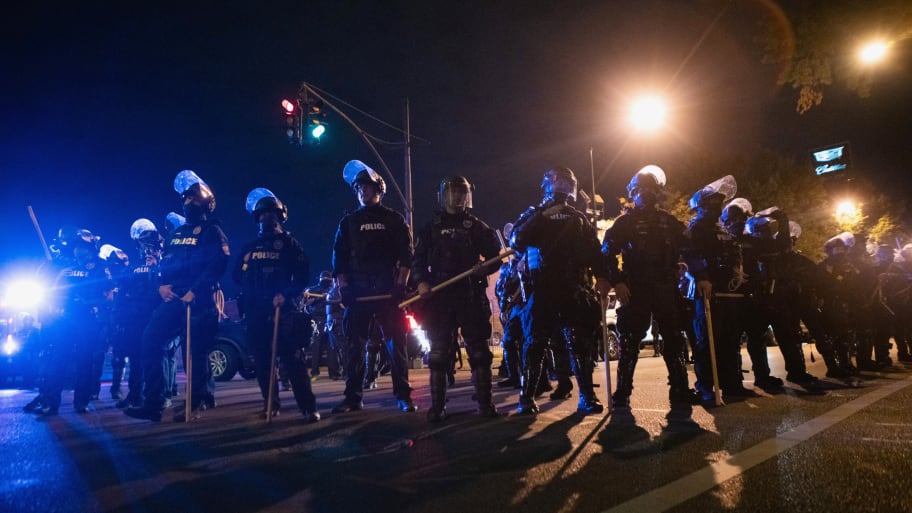 Louisville police block an intersection during a curfew amid protests.