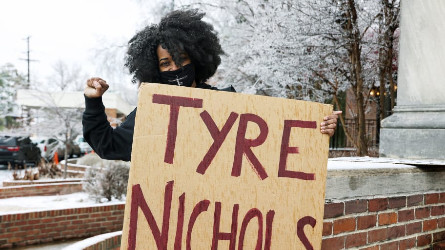 Nikita Young, from Fort Campbell, Kentucky, holds a placard before going into the memorial service for Black motorist Tyre Nichols who died after being beaten by Memphis Police officers, in Memphis, Tennessee, U.S. February 1, 2023. 