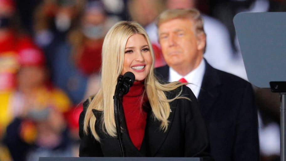 Donald Trump stands behind his daughter, Ivanka, while she speaks at a campaign event.