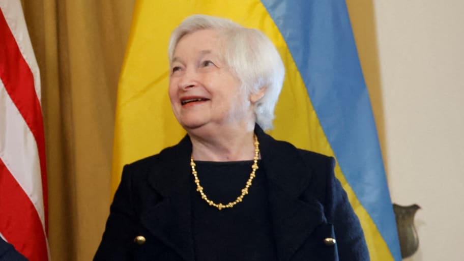 Janet Yellen in front of a Ukrainian flag.