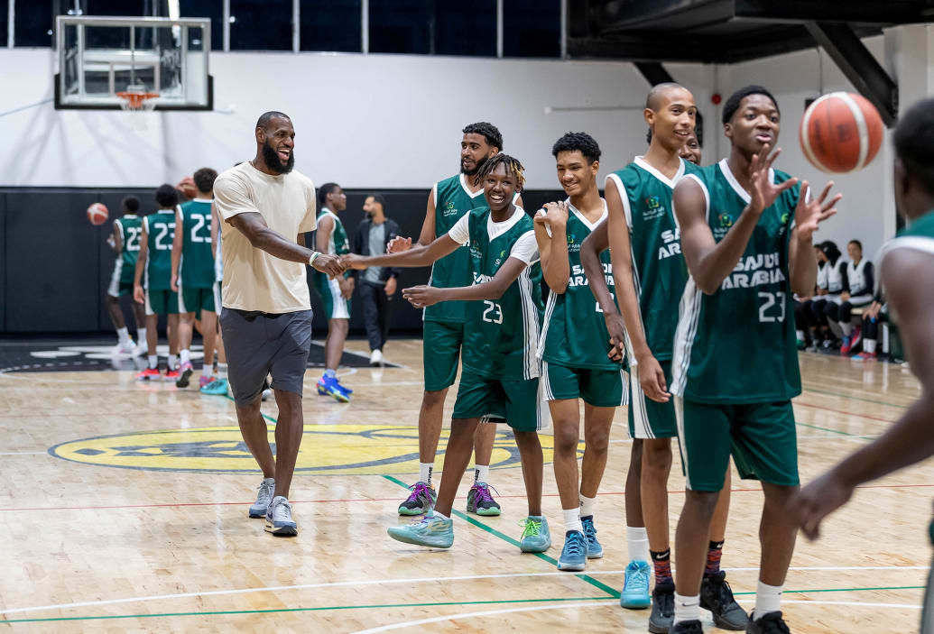 Los Angeles Lakers LeBron James and young Saudi players at a basketball clinic during a visit to Saudi Arabia.