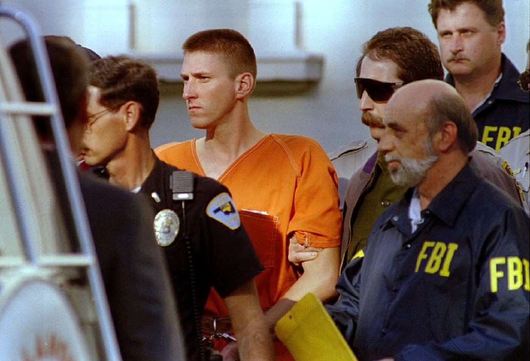 Oklahoma City building bomber Timothy McVeigh is escorted by police and FBI agents.