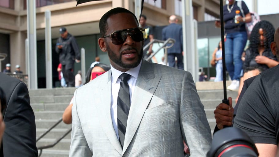 R. Kelly leaves court in a silver suit and sunglasses