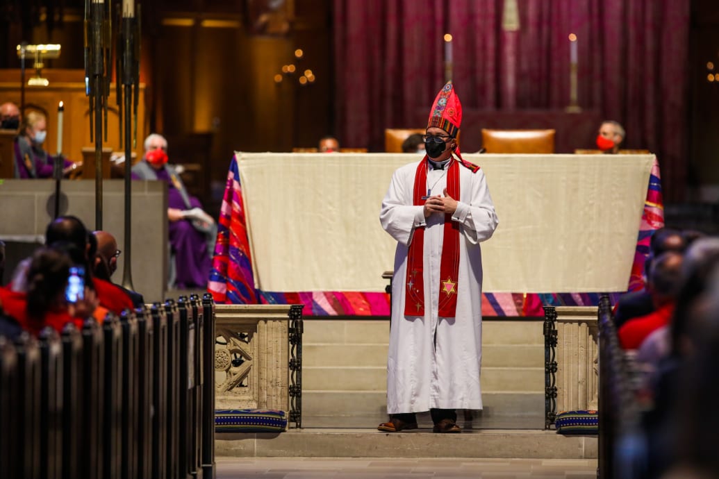 A photo of Rev. Dr. Megan Rohrer, the first openly transgender bishop of the Evangelical Lutheran Church in America, addressing their congregation..