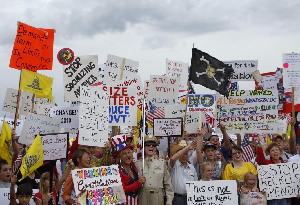 People hold signs during a tea party protest in Flagstaff, Arizona.