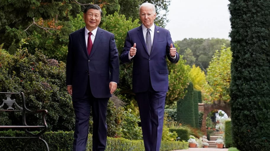 Joe Biden gives thumbs-up as he walks with Chinese President Xi Jinping at Filoli estate on the sidelines of the Asia-Pacific Economic Cooperation (APEC) summit, in Woodside, California, U.S., November 15, 2023. 