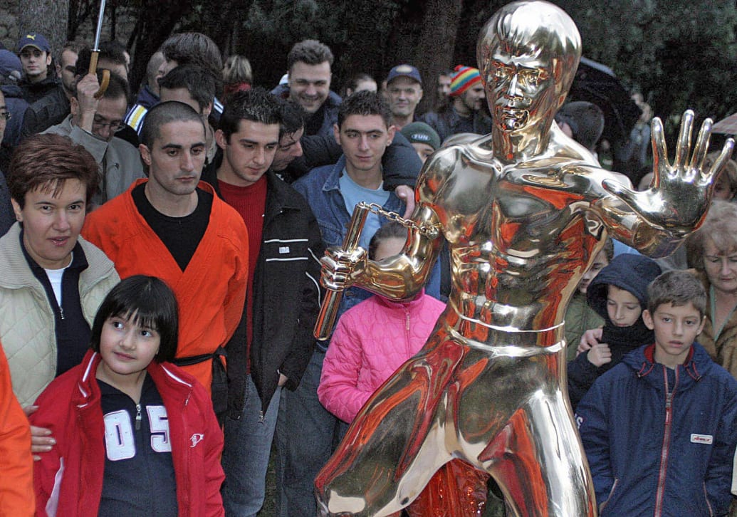 Bosnians and the statue of Bruce Lee in Mostar.