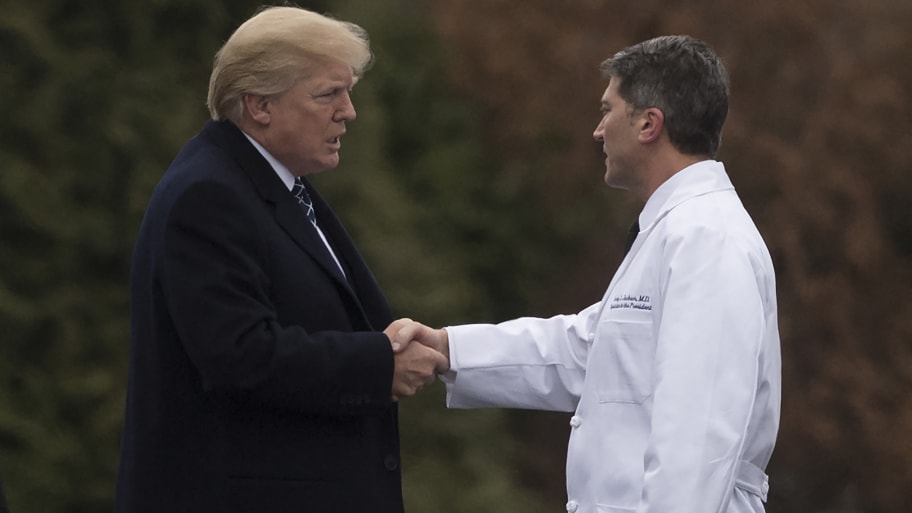 US President Donald Trump shakes hands with Dr. Ronny Jackson