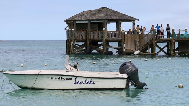 People gather on the resort pier after what police described as a fatal shark attack against a tourist at Sandals Royal Bahamian resort, in Nassau, Bahamas December 4, 2023.  