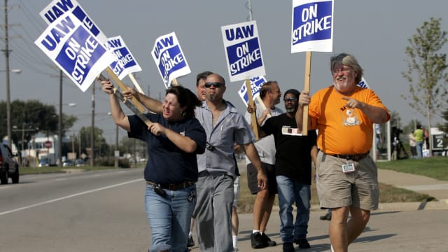 United Auto Workers (UAW) union members picket outside the General Motors Powertrain plant in Warren, Michigan