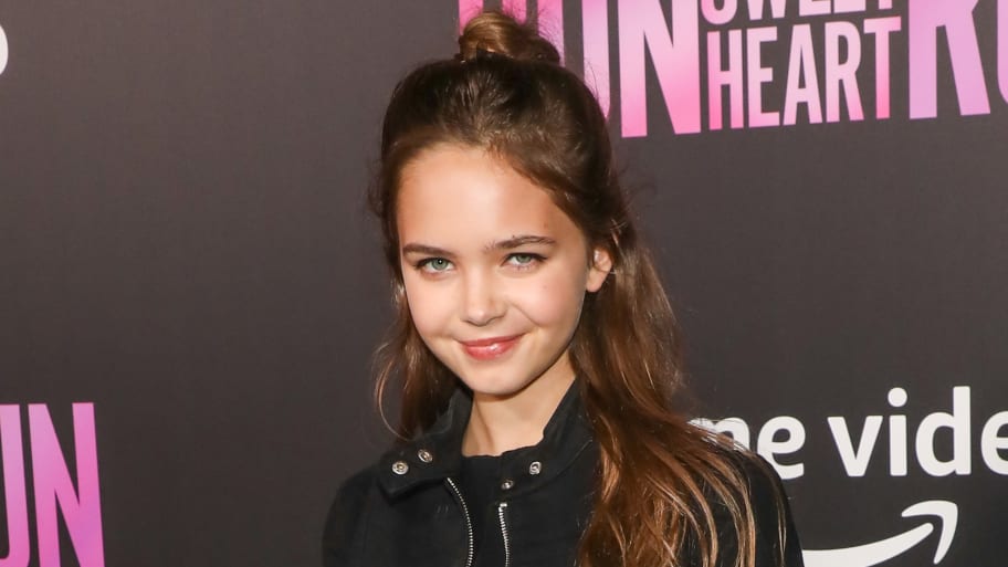 12-year-old actress Ryan Kiera Armstrong poses on the red carpet.
