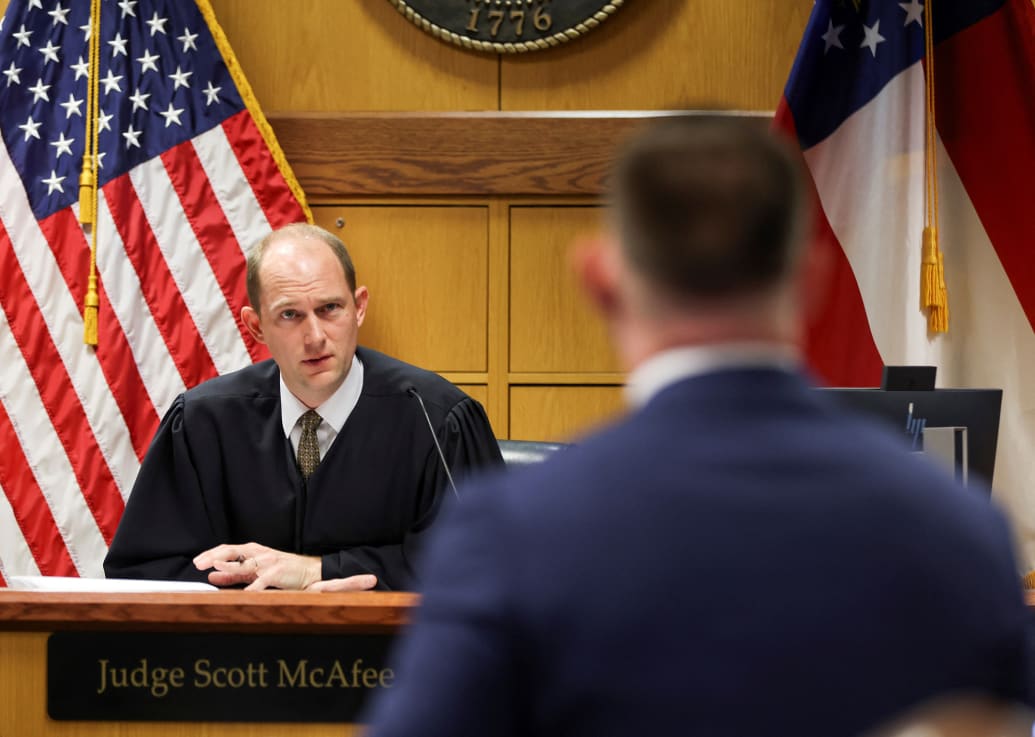Judge Scott McAfee listens to Fulton County prosecutor Will Wooten.
