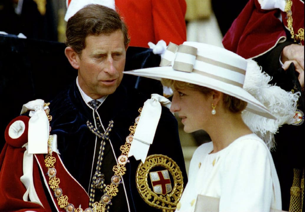 Prince Charles looks towards Princess Diana as they await their carriage to depart the Order of the Garter ceremony at Windsor Castle June 15, 1992.