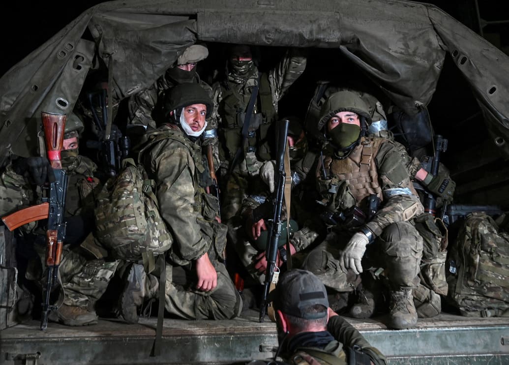 Russian Wagner mercenaries sit in the back of a transport truck in Russia after an attempted mutiny.