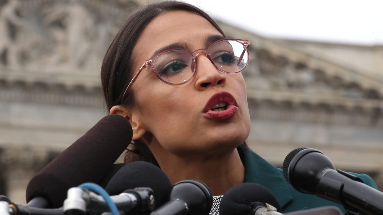 image of alexandra ocasio cortez speaking at capitol hill congress aoc green new deal ed markay resolution non binding environment climate change