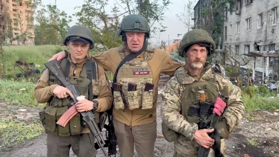 Wagner mercenary group founder Yevgeny Prigozhin poses with mercenaries during a statement on the start of withdrawal of his forces from Bakhmut, May 25, 2023.