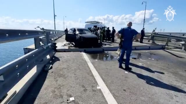 Russian authorities on scene at the Crimean bridge after a drone strike.