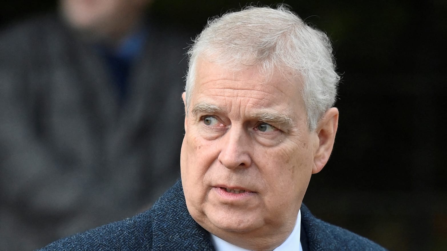 Prince Andrew in a gray coat and purple tie.