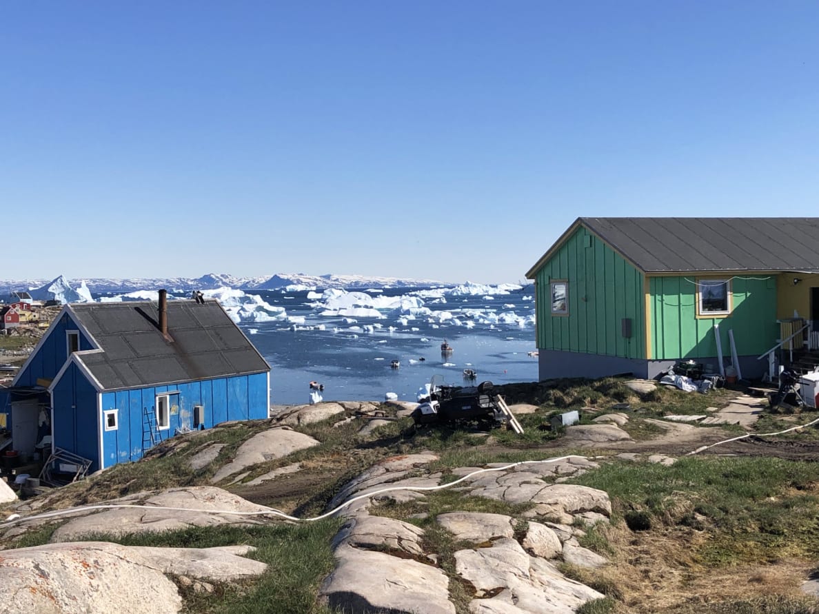 A photograph of the colorful clapboard houses in Saqqaq, Greenland.
