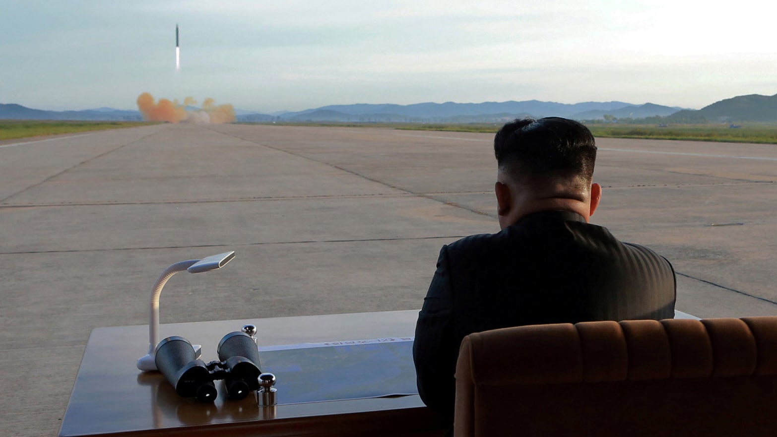 North Korean leader Kim Jong Un watches the launch of a Hwasong-12 missile.