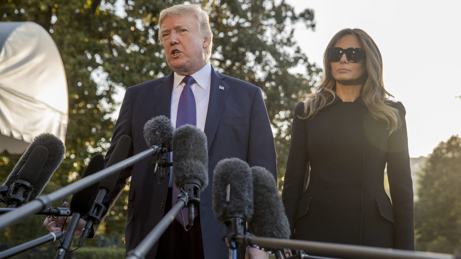 President Donald Trump, accompanied by first lady Melania Trump, speaks to reporters before travelling to Las Vegas to visit with victims and first responders affected by the worst mass shooting in American history