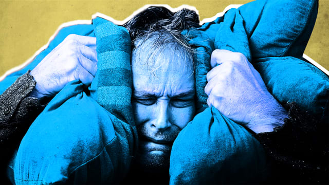 man colored in blue is in angst and holding two pillows by each ear